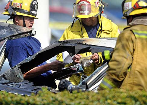 (Picture Courtesy of the O.C. Register) “A man is dead after being shot and crashing into a tree outside the MainPlace mall.  The man was stopped in an older model...