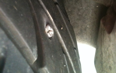 Tire with screw embedded (landscape crop) Tire with screw embedded