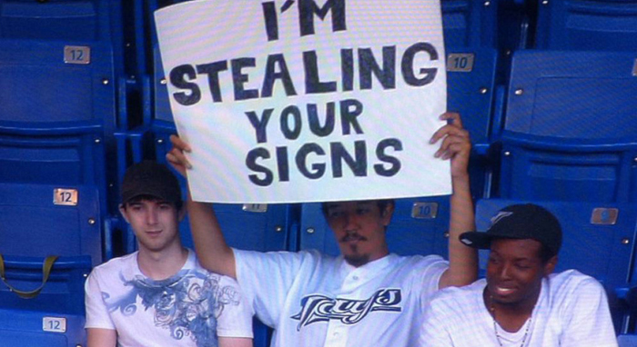 stealing signs Toronto baseball fans hold up sign claiming that they are stealing signs