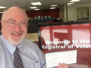 Greg with check at Registrar of Voters 300 px