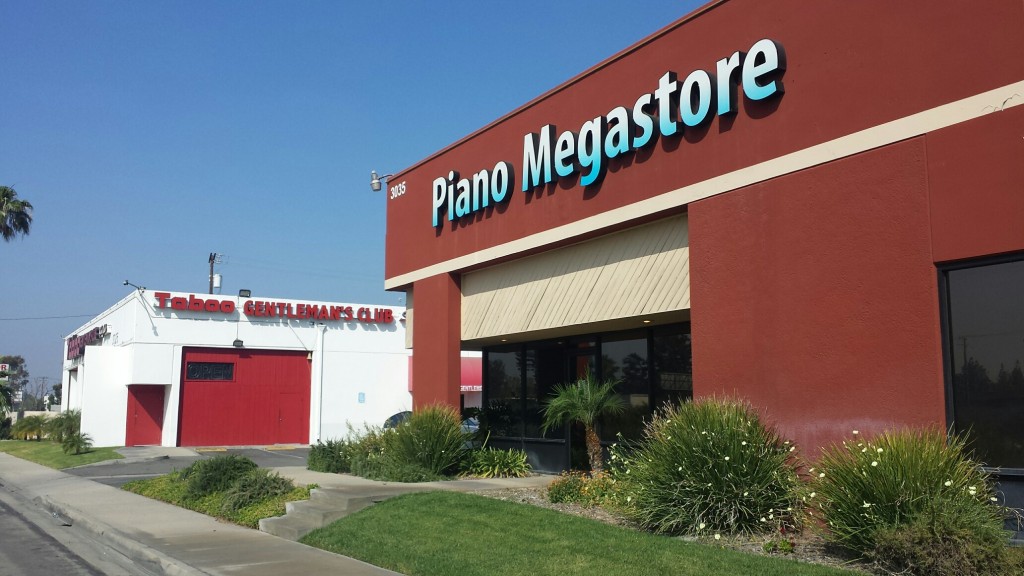 The closest businesses to the proposed site - piano store and strip club!