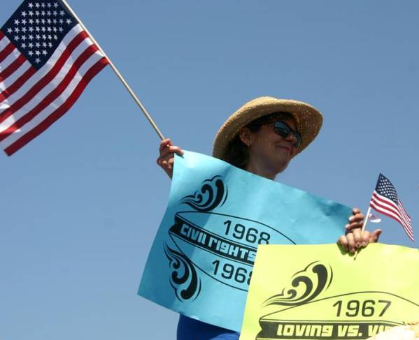 Louise Stewardson waving the flag for civil rights accomplishments at the Huntington Beach 4th of July parade.