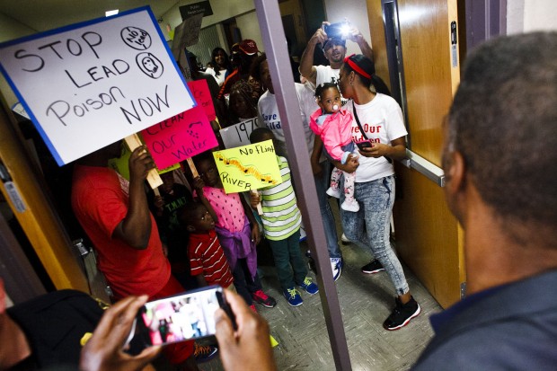 "Protestors make their way to city hall council chambers chanting for clean water at Flint City Hall in Flint, Mich. on Wednesday Oct. 7, 2015. (Christian Randolph/Flint Journal)"