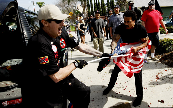 Grand Dragon Quigg and unnamed Antifa struggle over flag/weapon. Picture from LA Times.