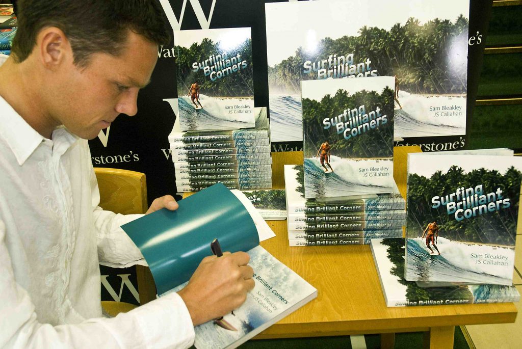 This public domain photo of Same Bleakley signing a book on surfing has been SCIENTIFICALLY DESIGNED to optimize the chance of Martin Wiskcol coming to read this blog.