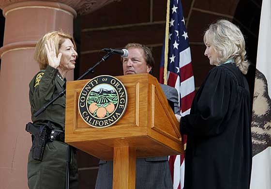 (Editor’s Note: Picture taken by Steve Sarkis). The opening of today’s Orange County Board of Supervisors meeting was the Swearing in Ceremony for Sheriff-Coroner Sandra Hutchens held on the steps […]